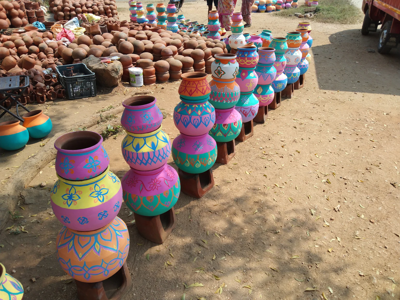 Comparison of terracotta clay
    pots and colorful plastic pots in a garden