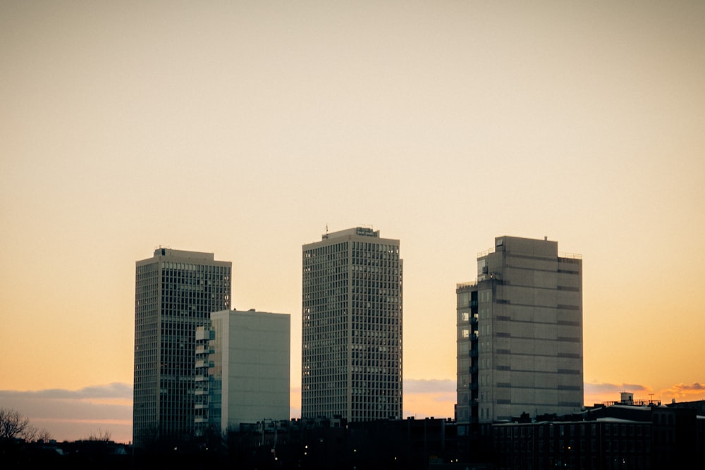 a sunset over a body of water with a city in the background