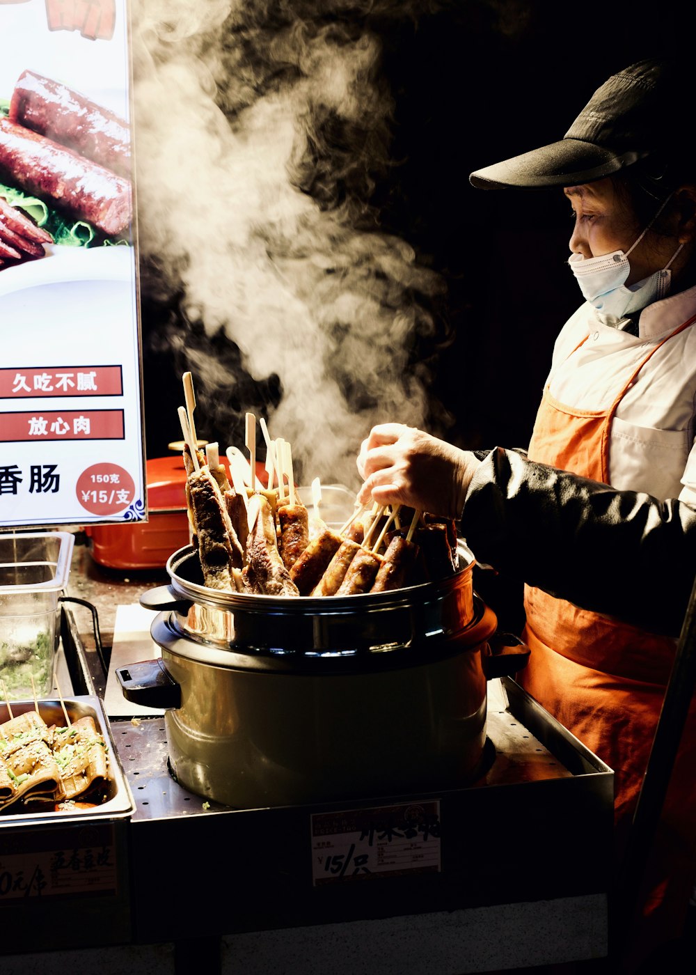 a man cooking food in a large pot