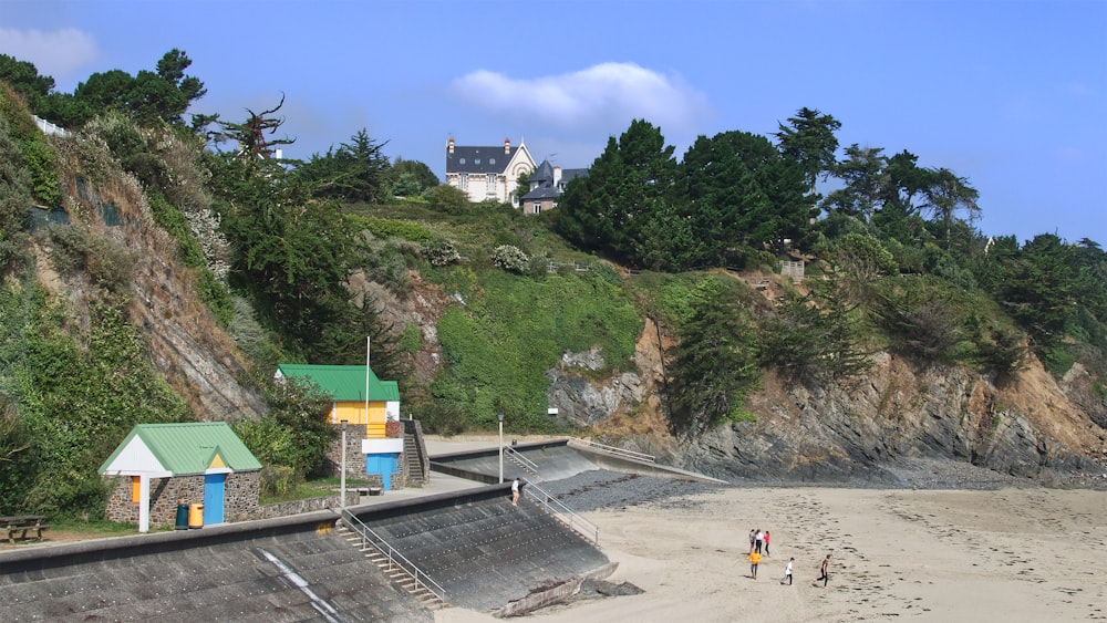 a couple of people standing on top of a sandy beach