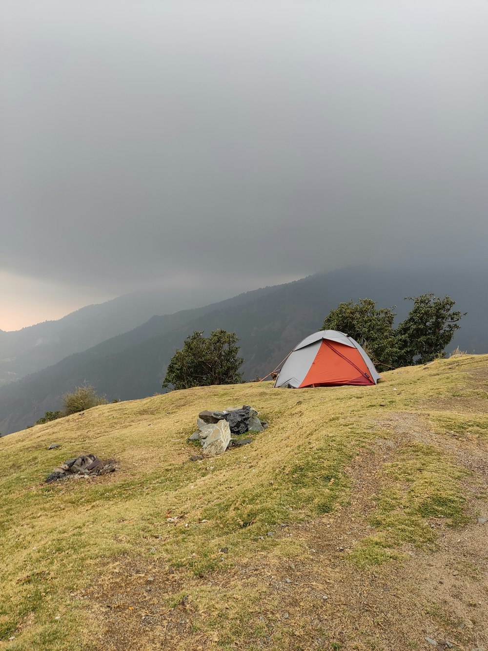 a tent pitched up on top of a hill