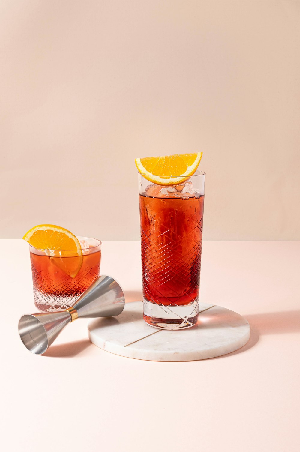 a couple of glasses filled with drinks on top of a table