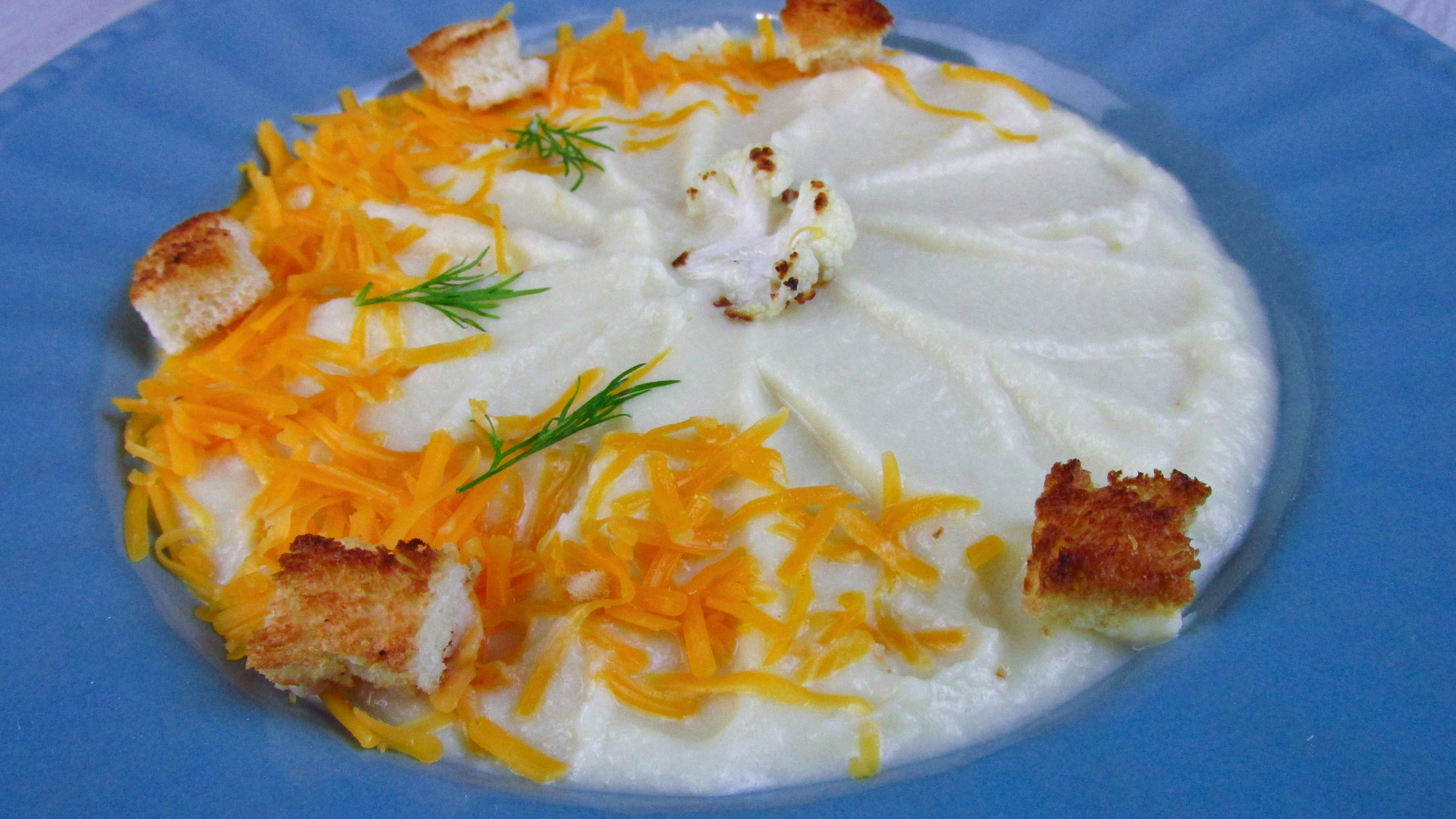 a blue plate topped with cheese and crackers