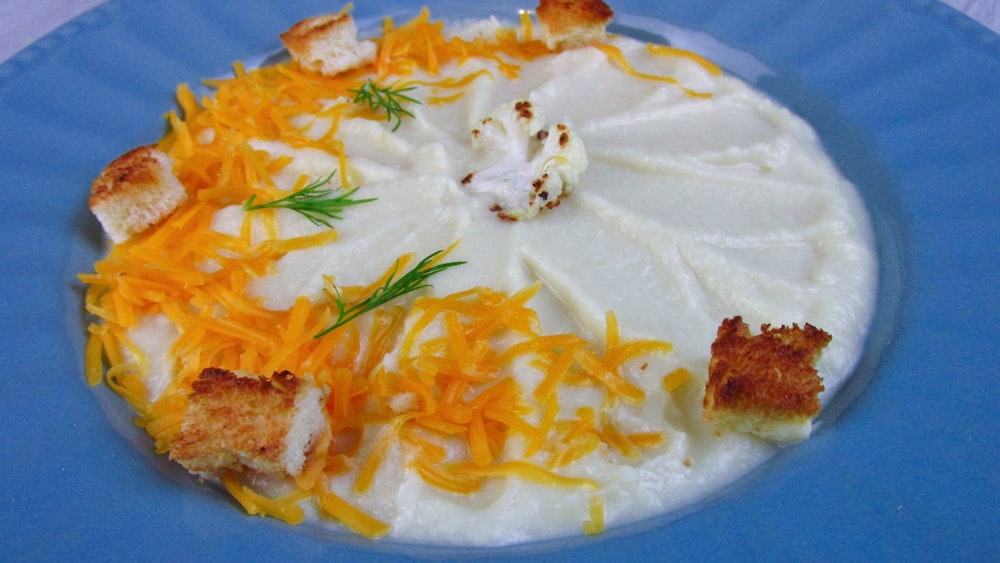 a blue plate topped with cheese and crackers