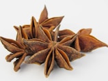 a group of star anise on a white background