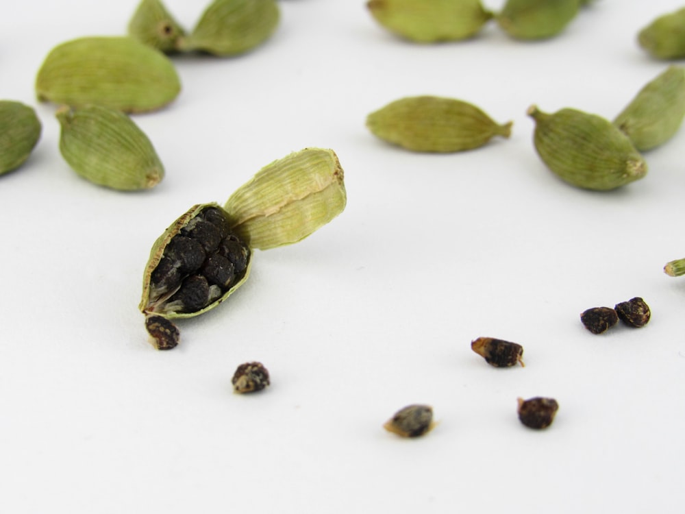 pistachios and seeds on a white surface