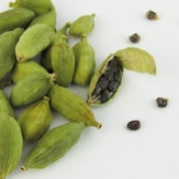 a pile of green beans sitting on top of a white table