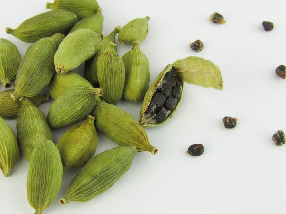 a pile of green beans sitting on top of a white table