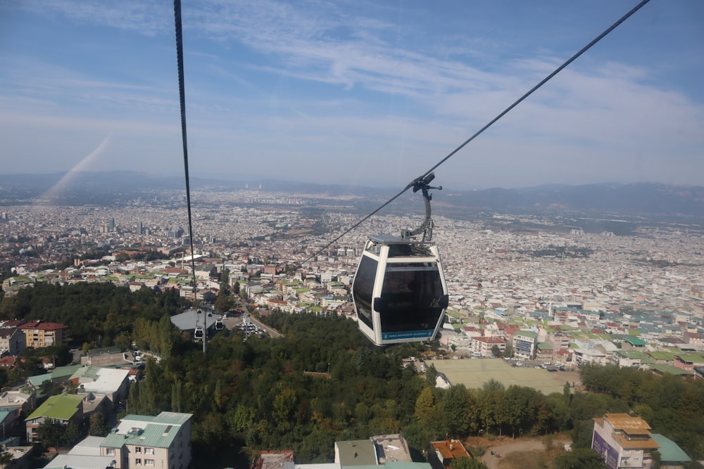 a gondola with a view of a city below
