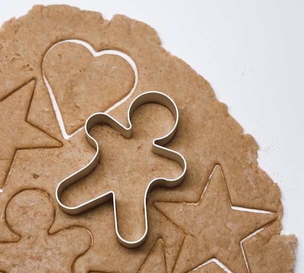 a cookie with a cookie cutter in the shape of a heart and a star