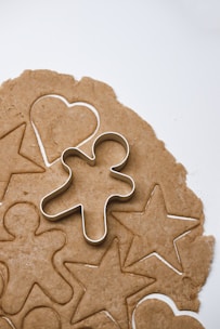a cookie with a cookie cutter in the shape of a heart and a star