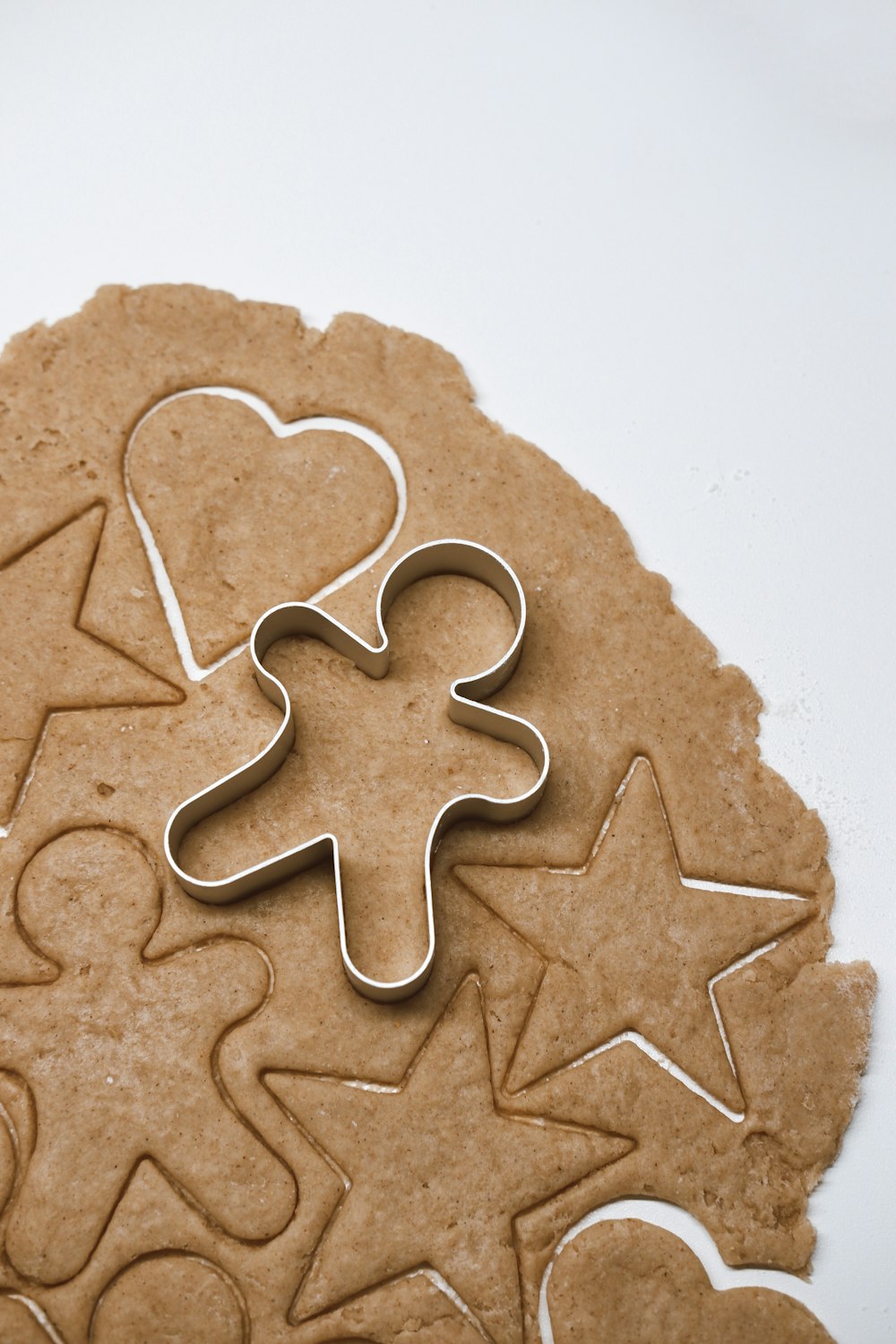 a cookie with a cookie cutter in the shape of a heart and a star