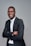 a man in a suit and glasses posing for a picture