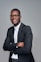 a man in a suit and glasses posing for a picture