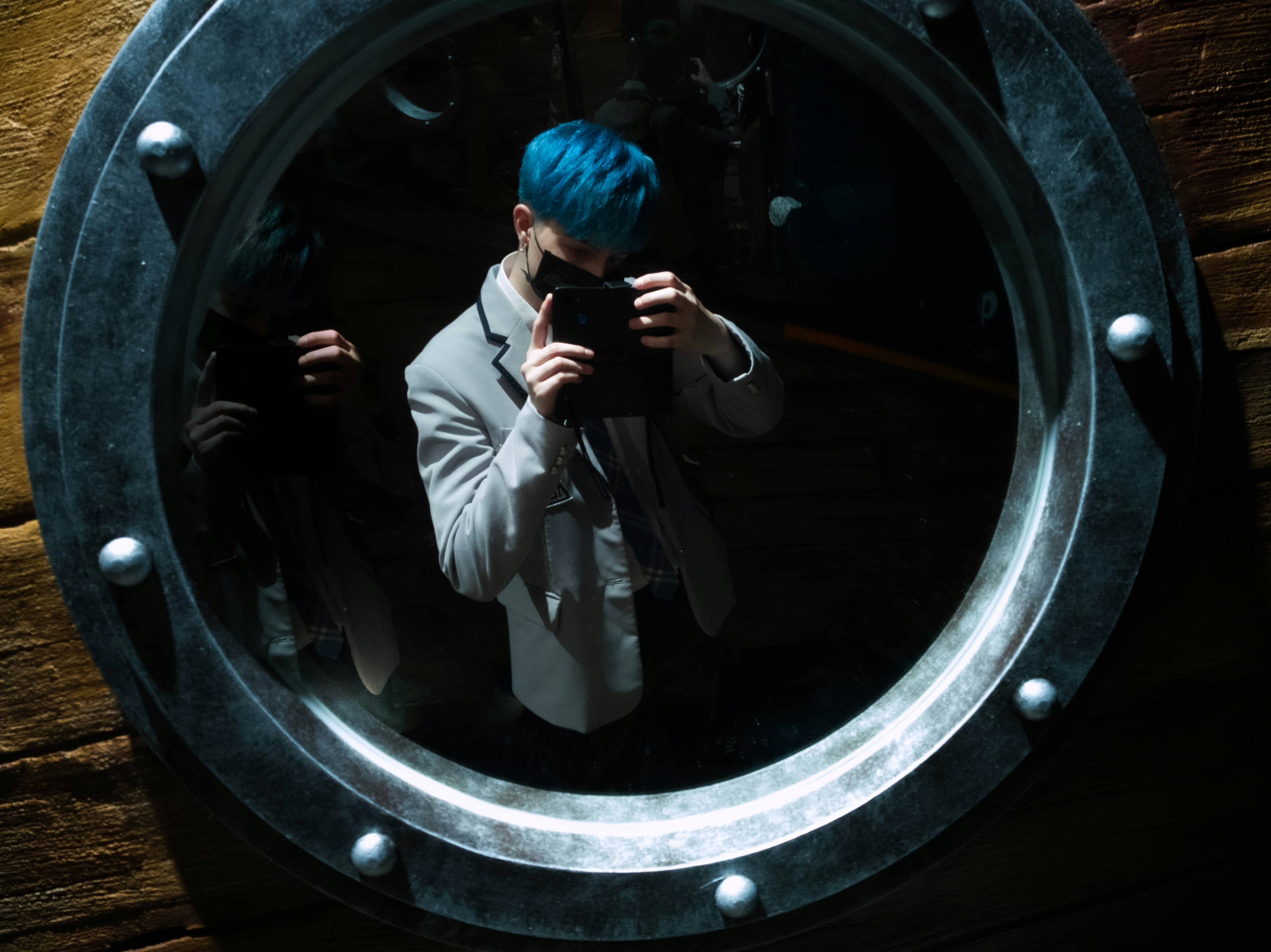 a person taking a picture of themselves in a mirror