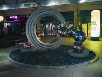 a sculpture in the middle of a street at night