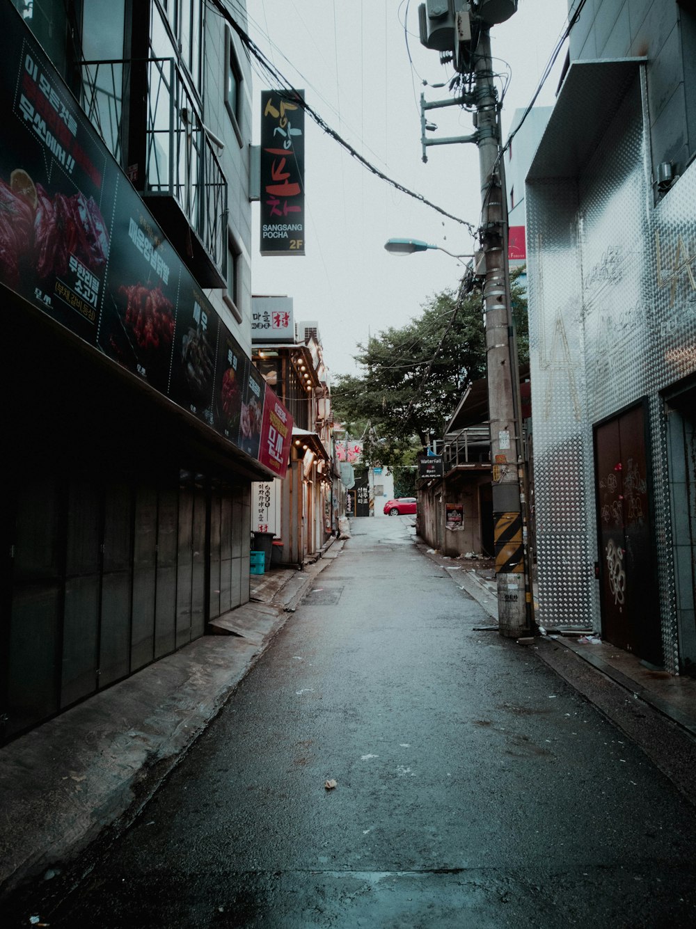 a narrow city street with buildings on both sides