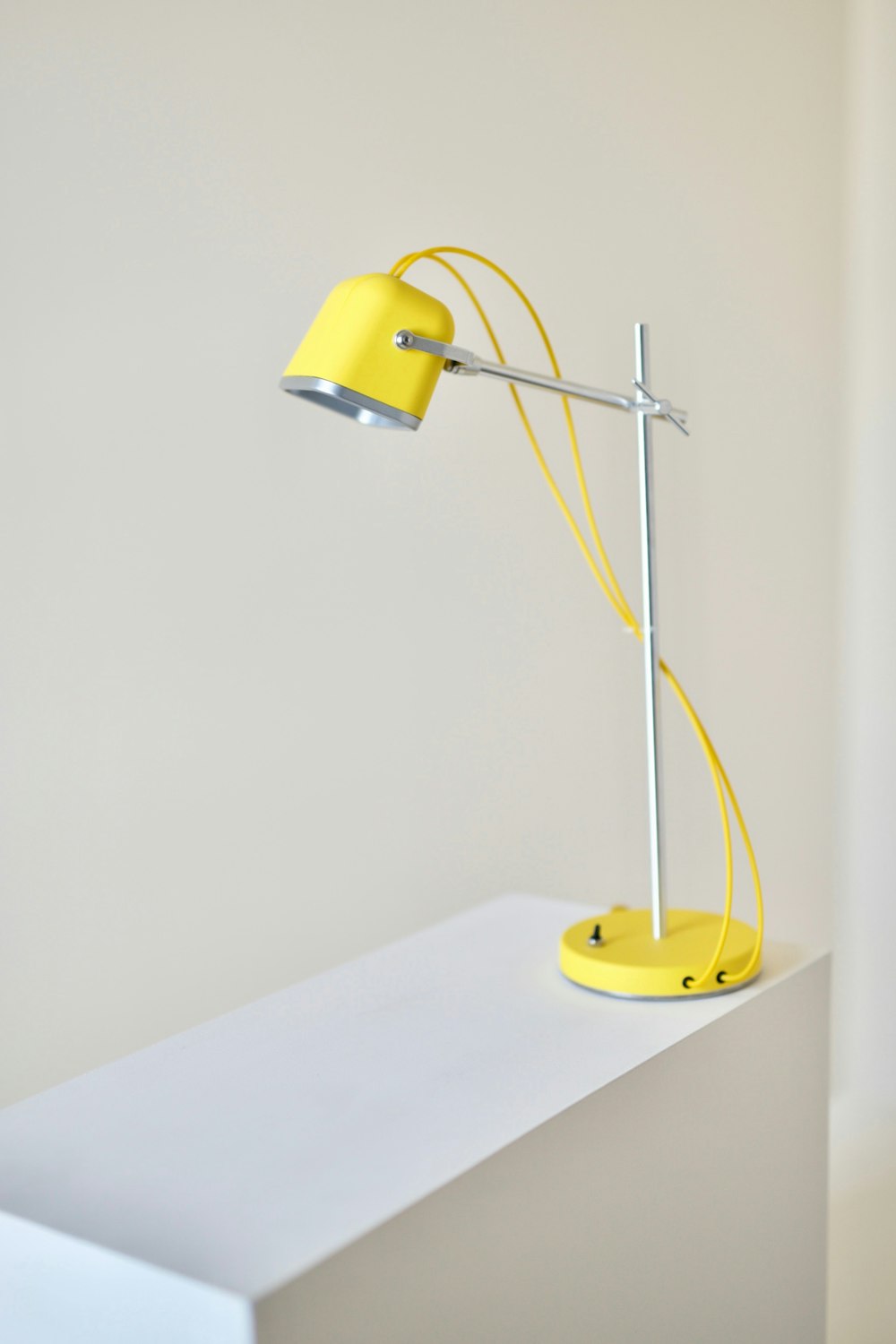 a yellow lamp sitting on top of a white counter