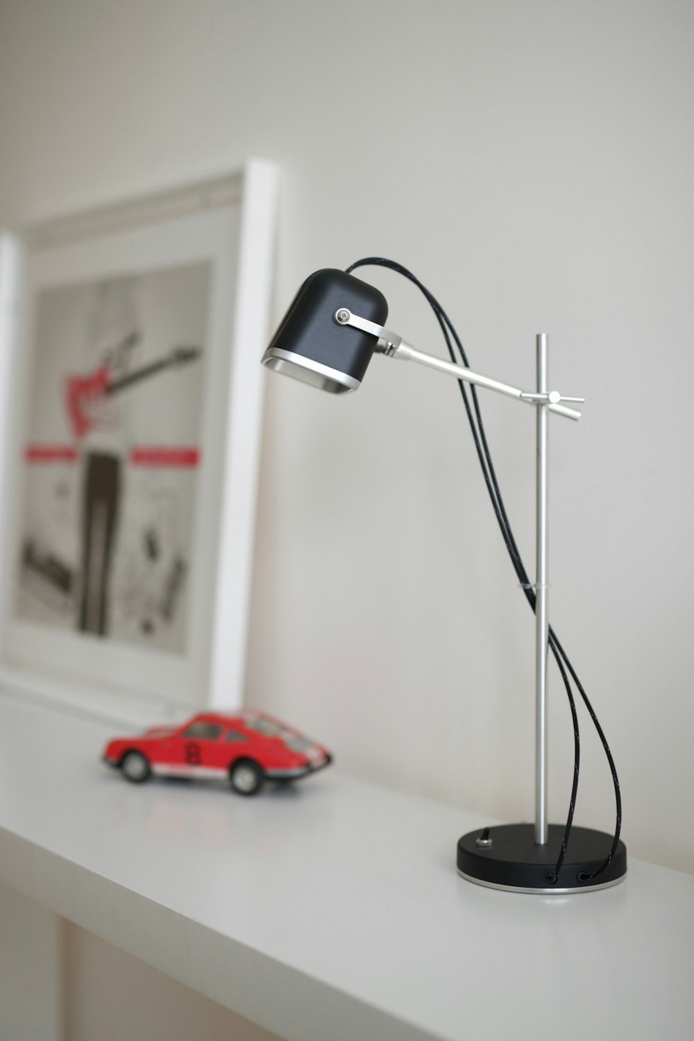 a desk lamp sitting on top of a white table