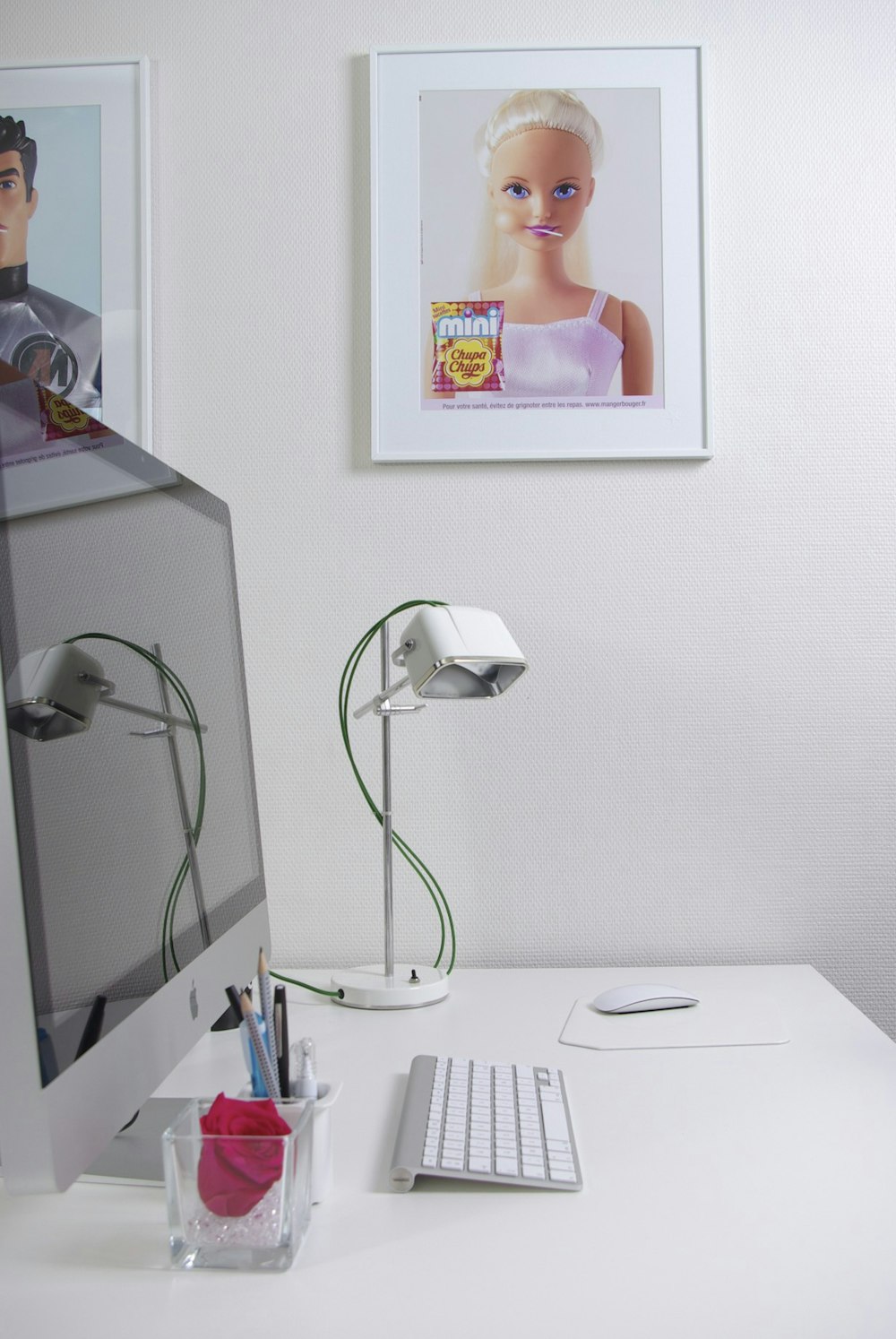 a white desk with a computer monitor and keyboard