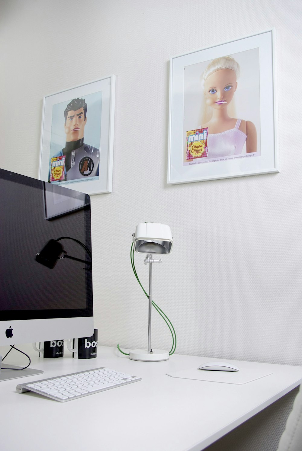 a white desk with a computer monitor and keyboard