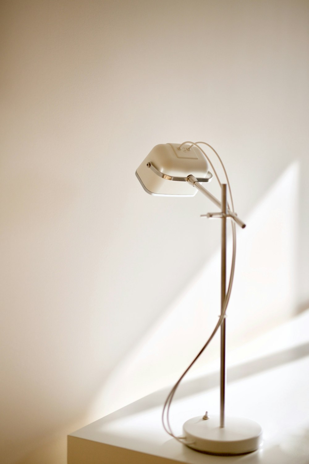 a floor lamp sitting on top of a white table