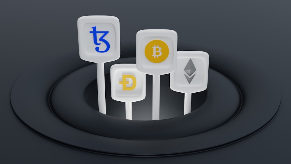 a set of three white and yellow bitcoins sitting on top of a black