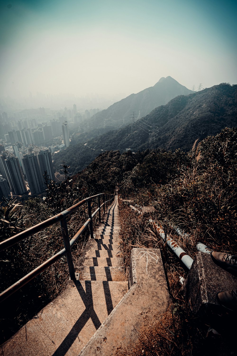 a stairway with a view of a city in the distance