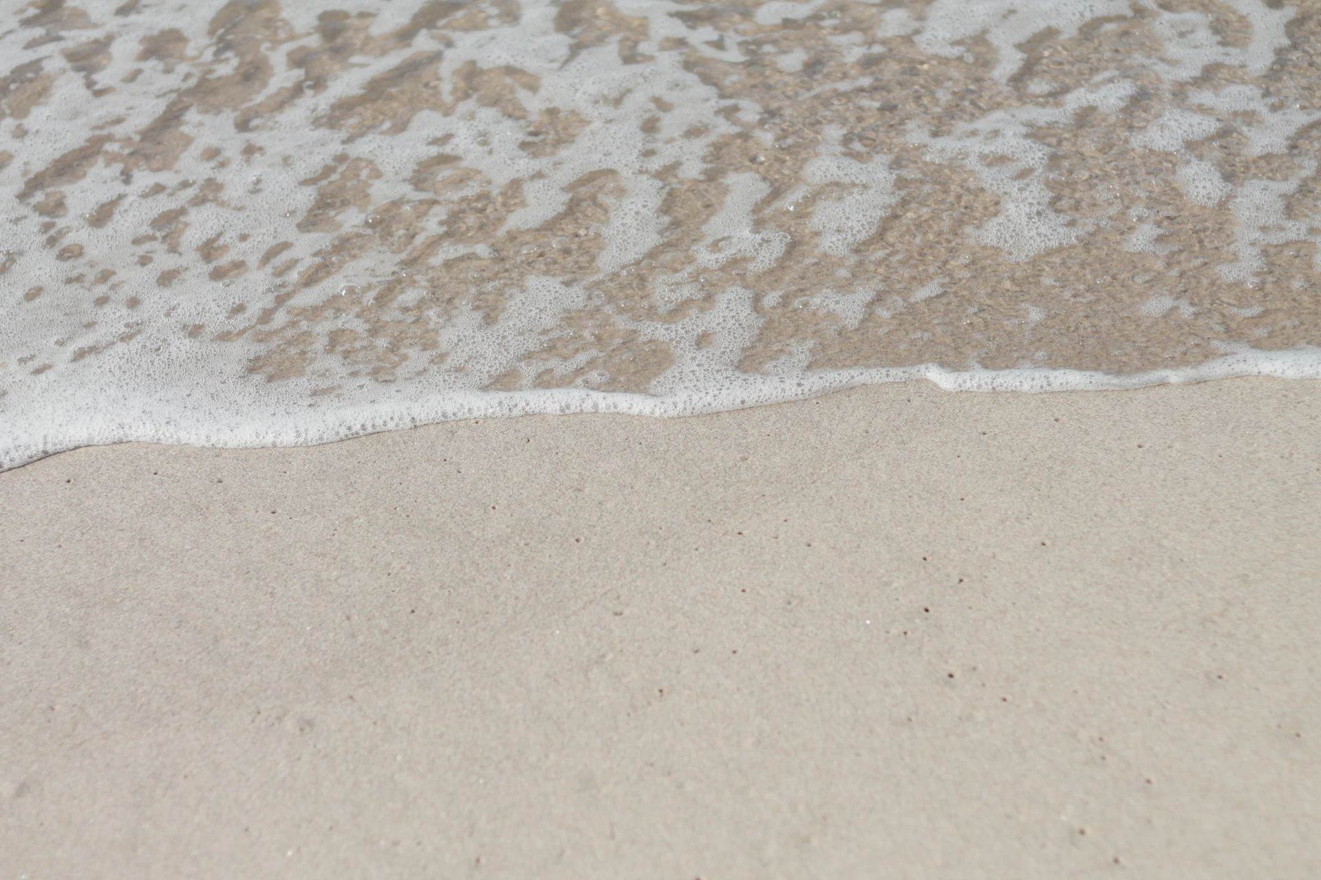 a close up of a wave on a beach