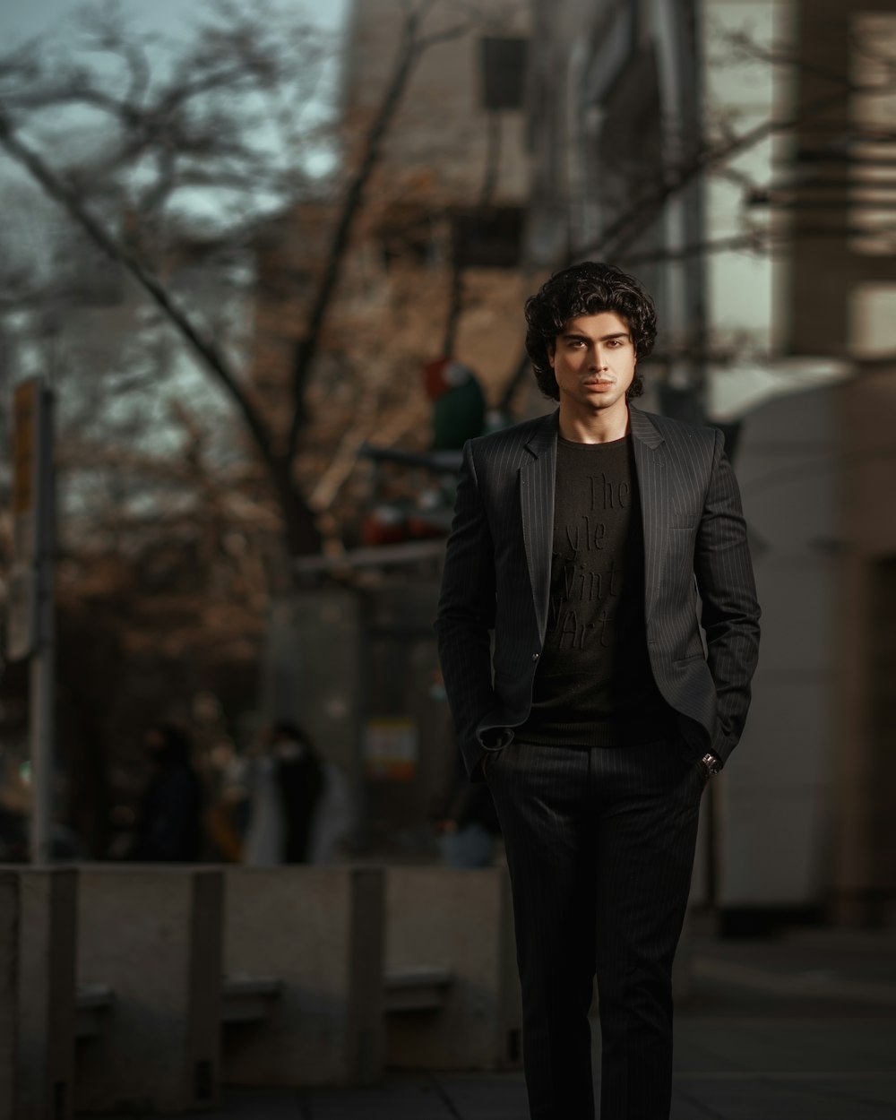 a man in a suit is walking down the street