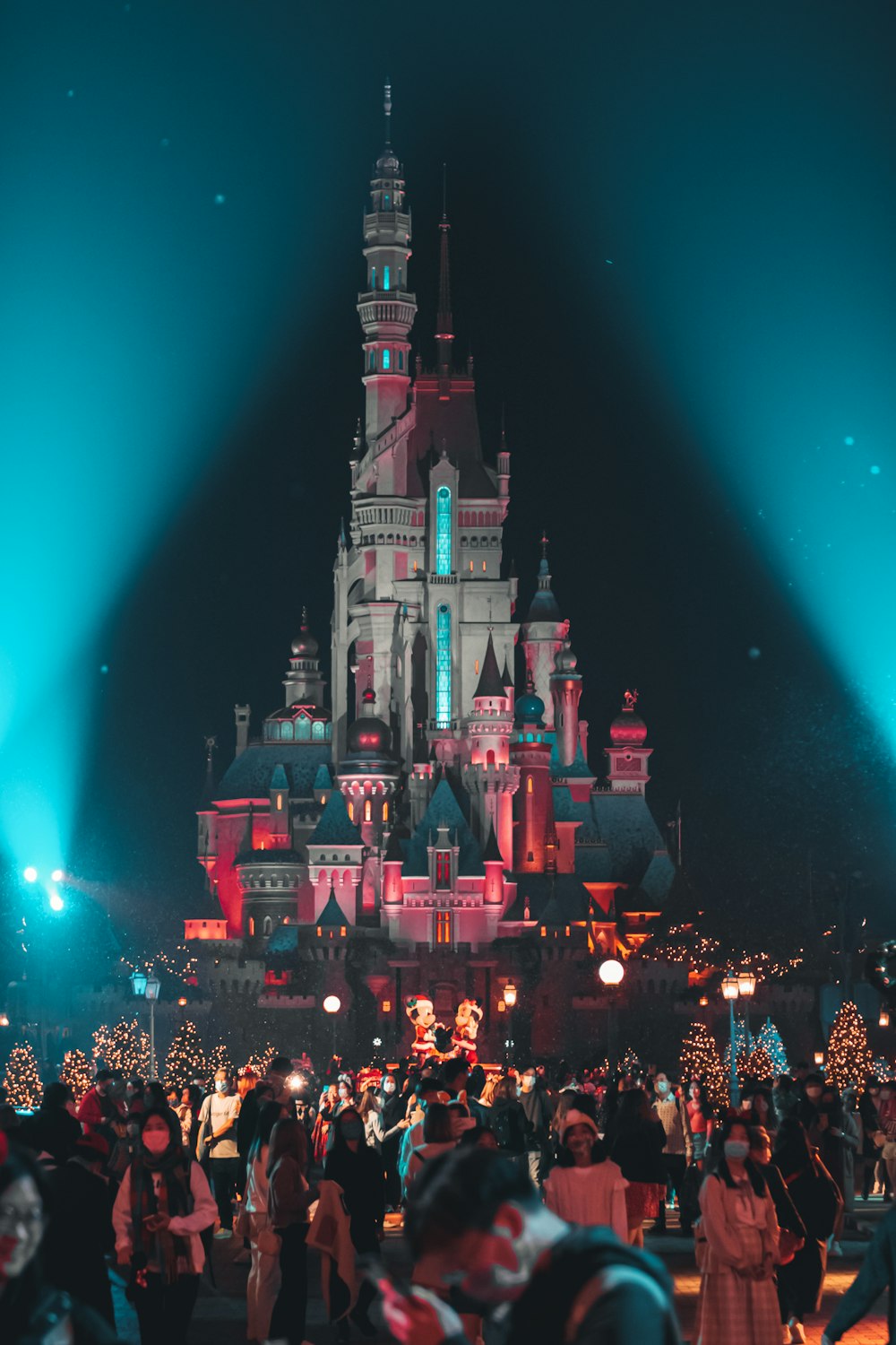 a crowd of people standing in front of a castle