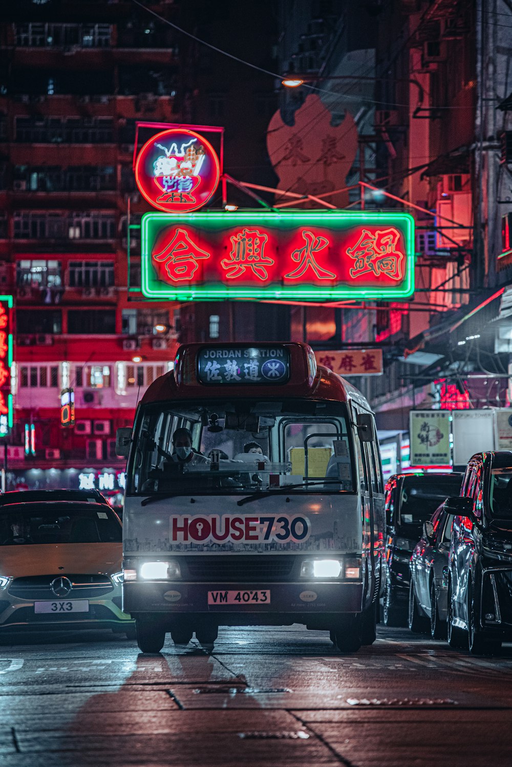 a bus driving down a city street at night