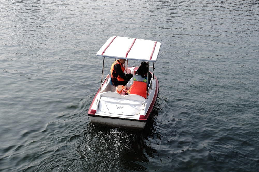 two people in a small boat on a body of water