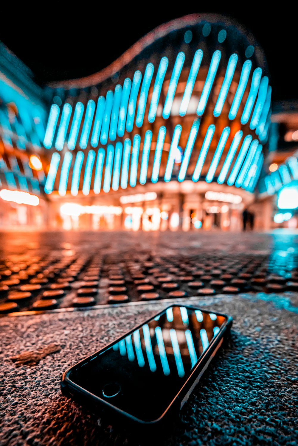 a cell phone laying on the ground in front of a building