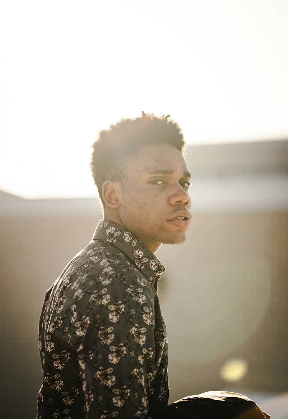 a man with a black shirt and a flowered shirt