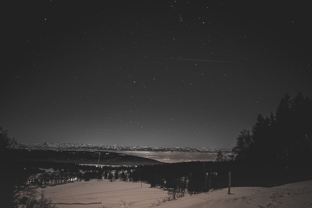 a black and white photo of the night sky