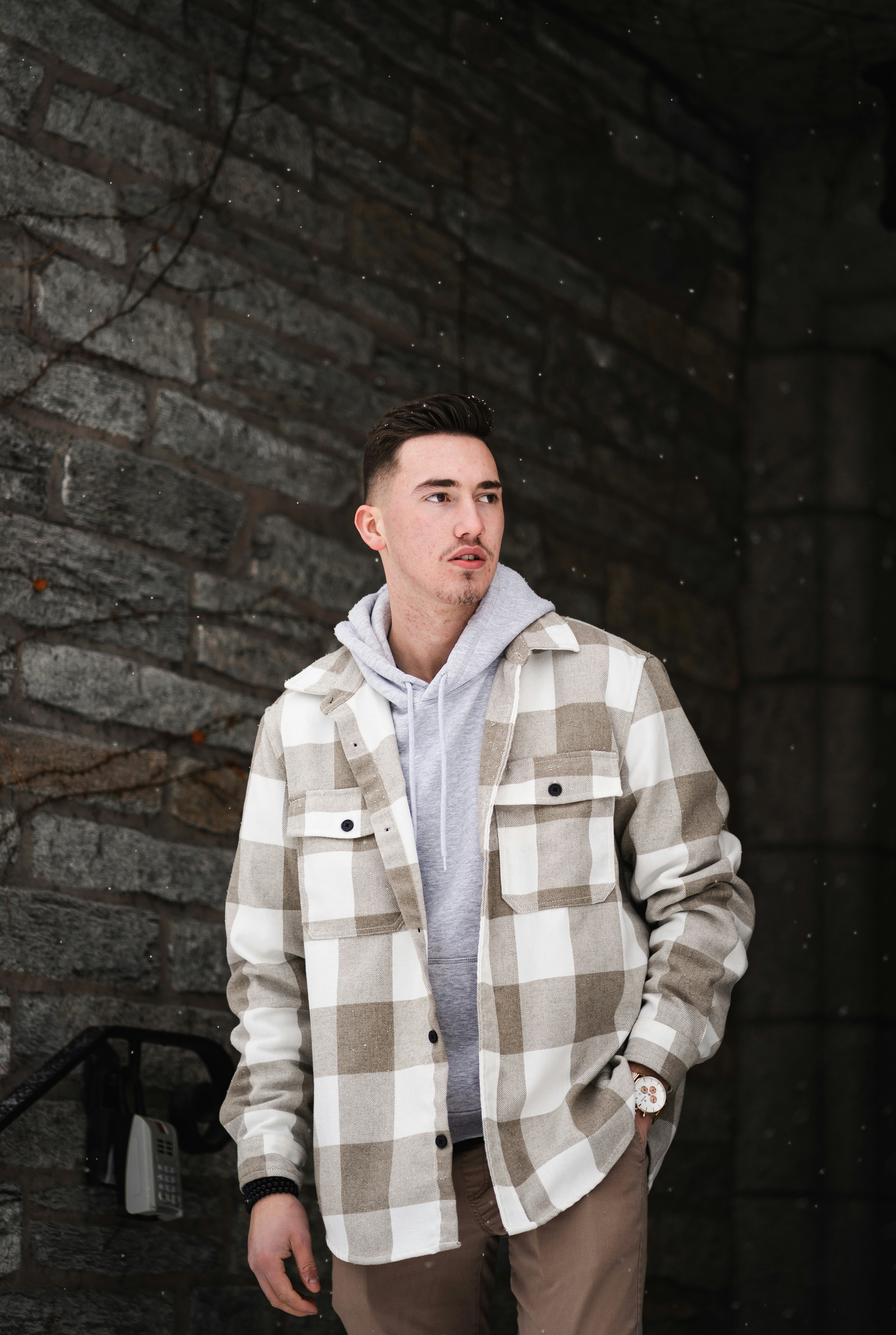 A man standing in front of a brick wall photo – Free Grey Image on Unsplash