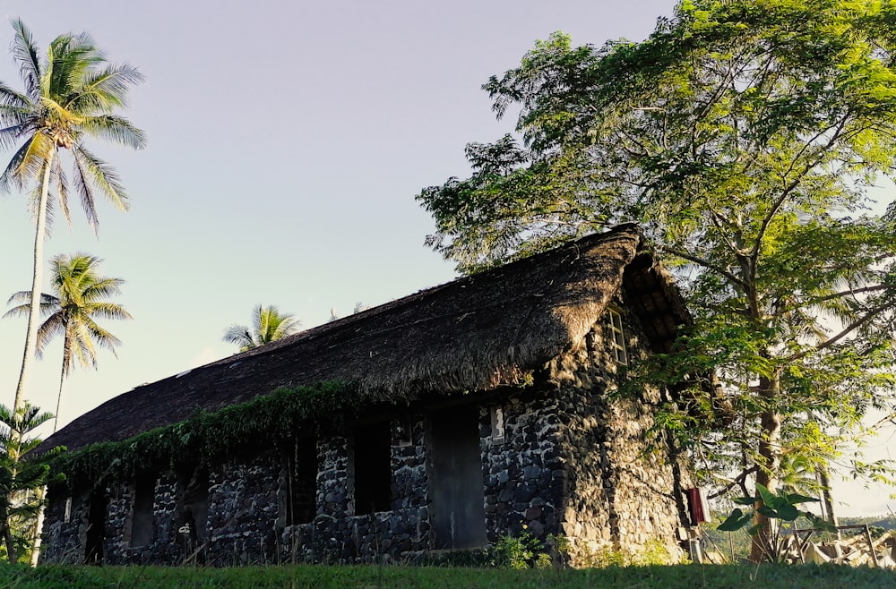 an old stone building with a thatched roof