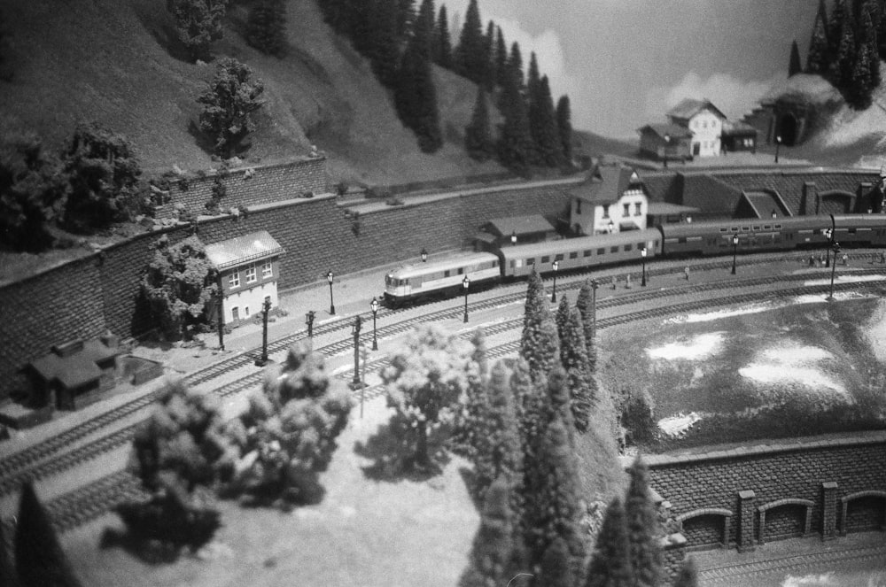 a black and white photo of a model train set
