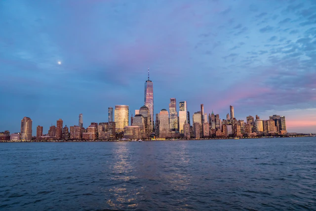 New York Lower Manhattan skyline and One World Trade Center across the Hudson River at dusk