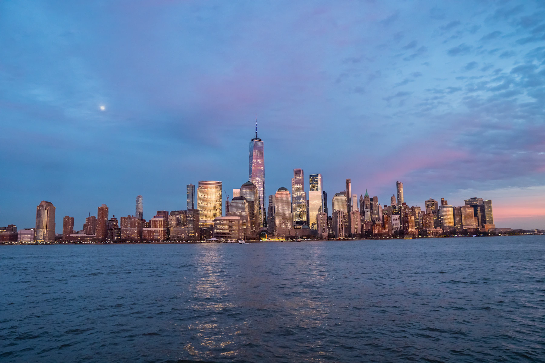 New York Lower Manhattan skyline and One World Trade Center across the Hudson River at dusk