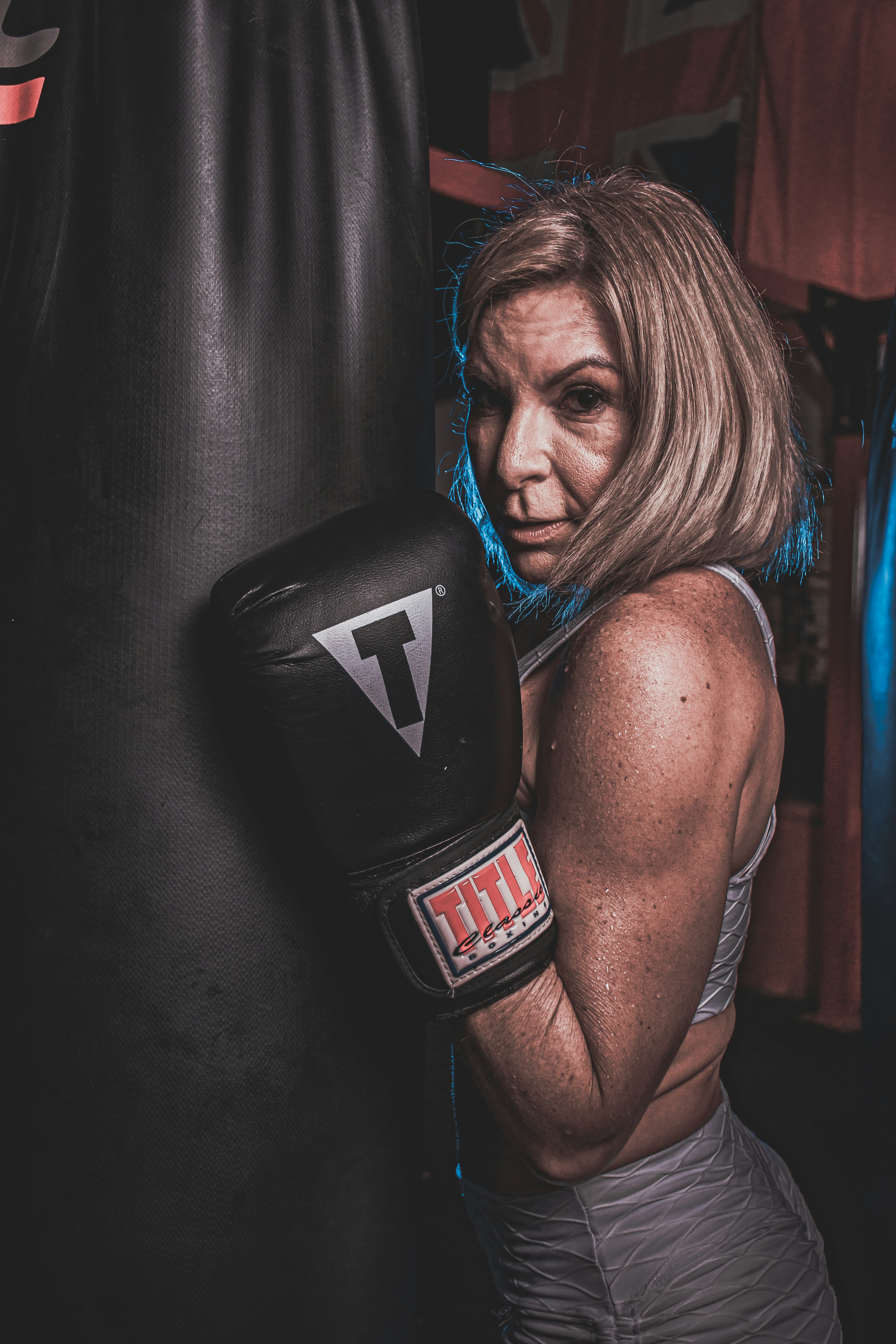 a woman wearing boxing gloves posing for a picture