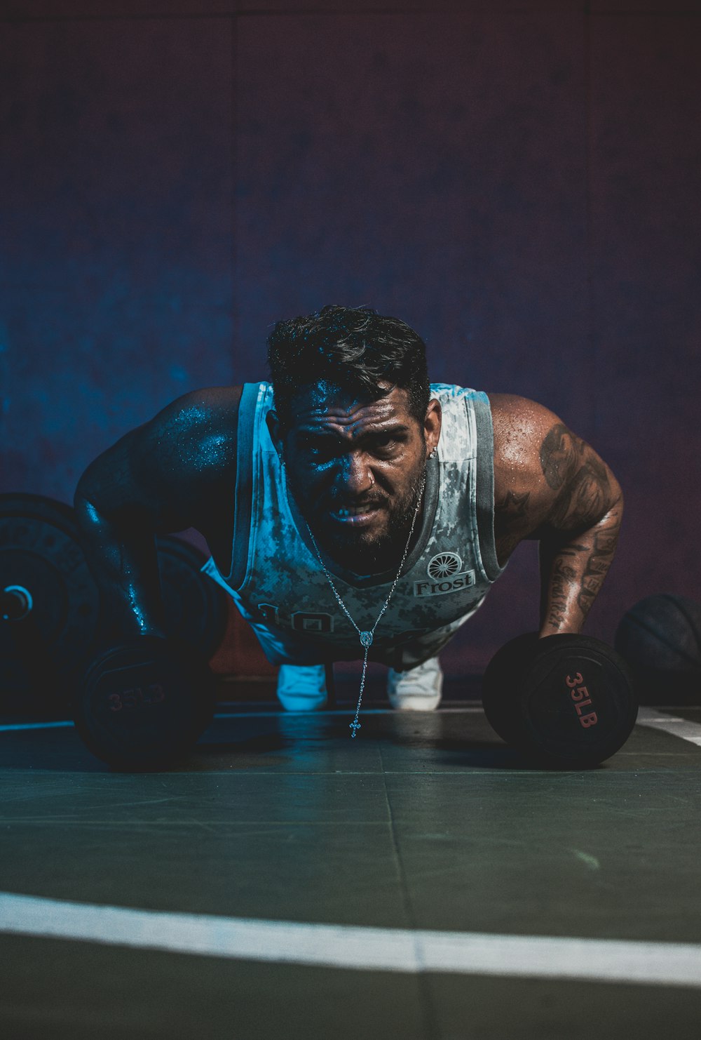 a man doing push ups with a barbell