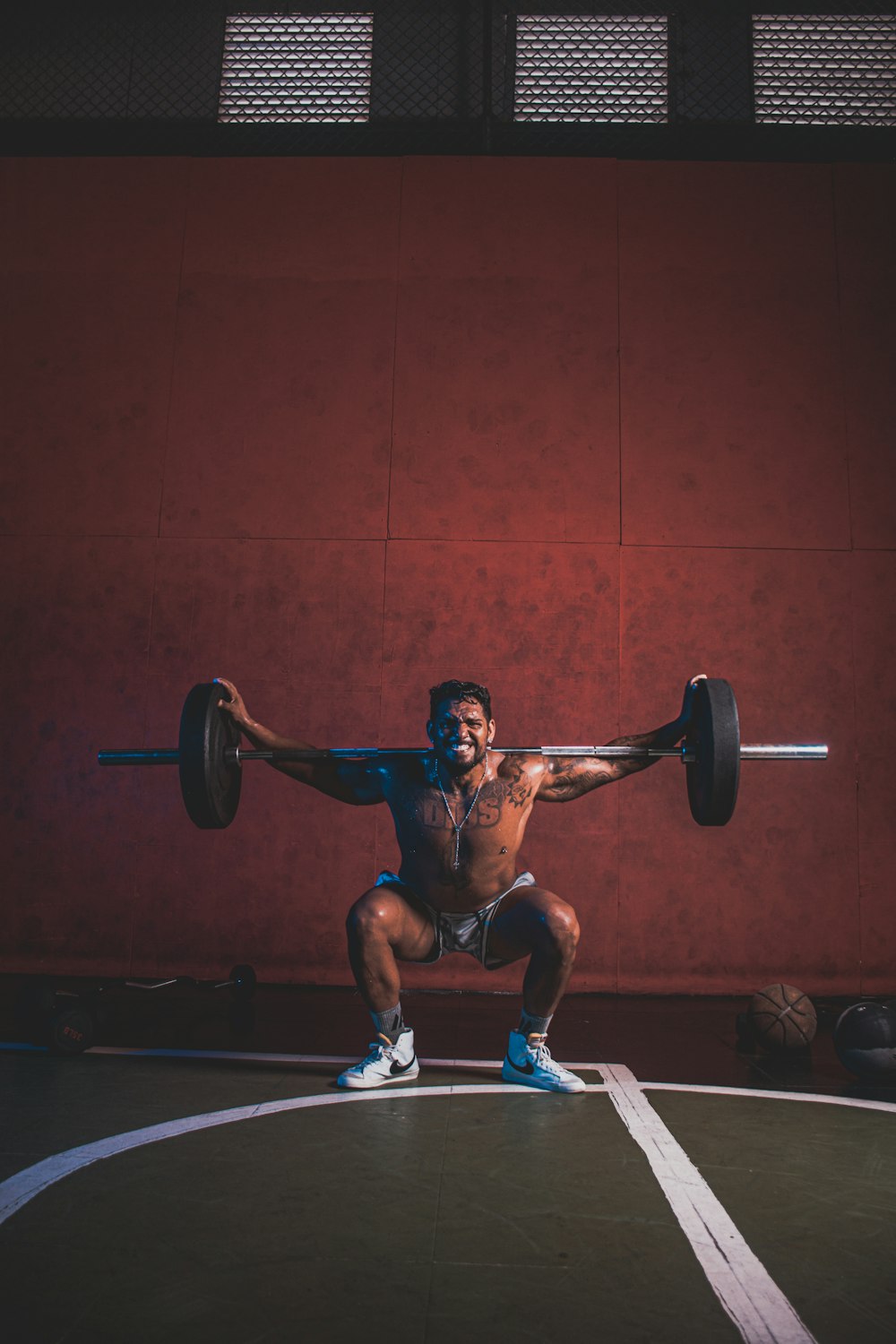 a man doing a squat with a barbell