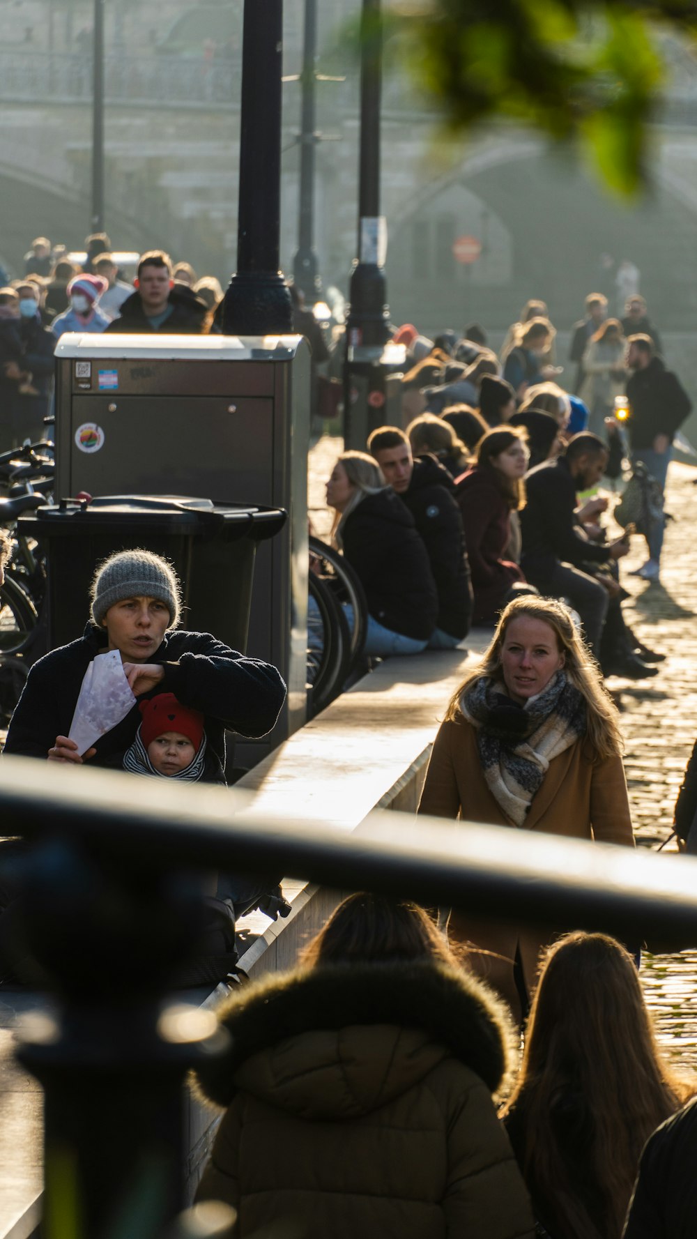 a group of people sitting on a sidewalk