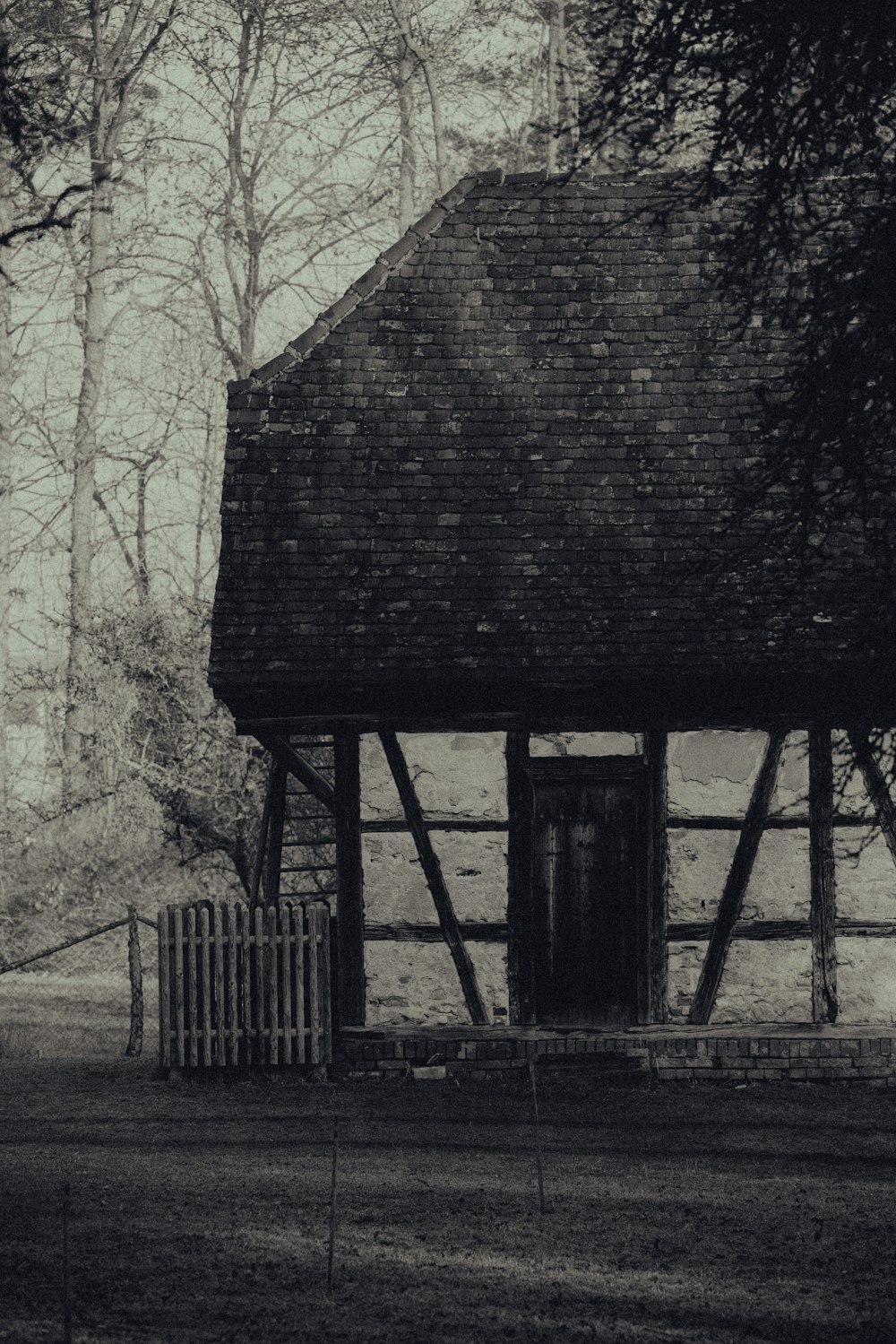 a black and white photo of an old house