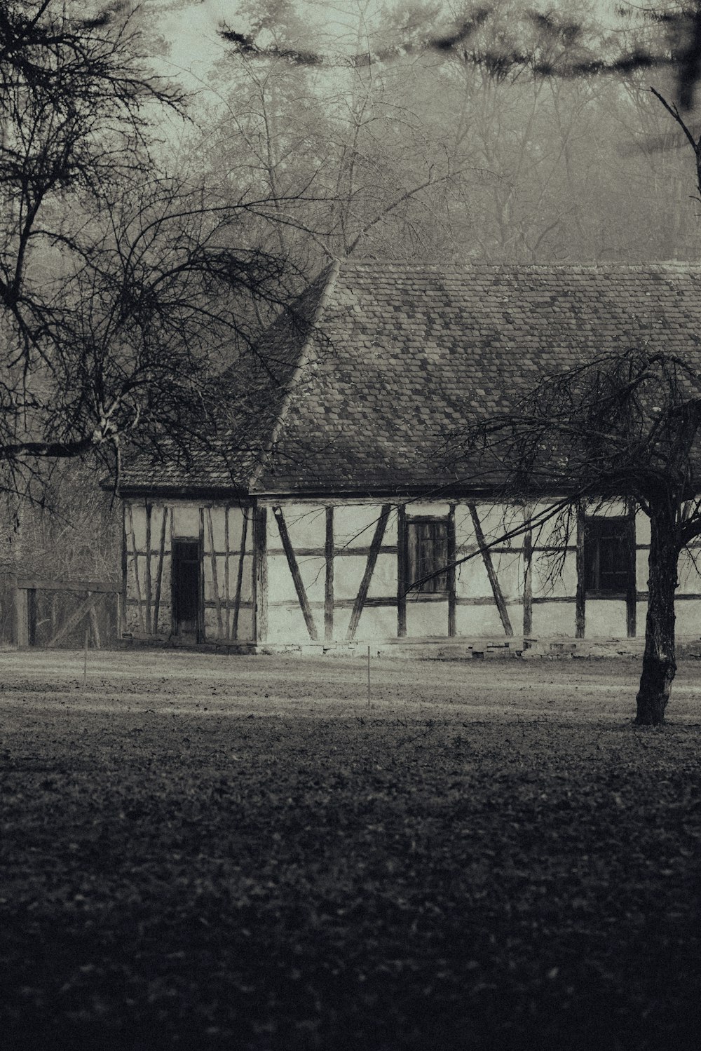 a black and white photo of an old house