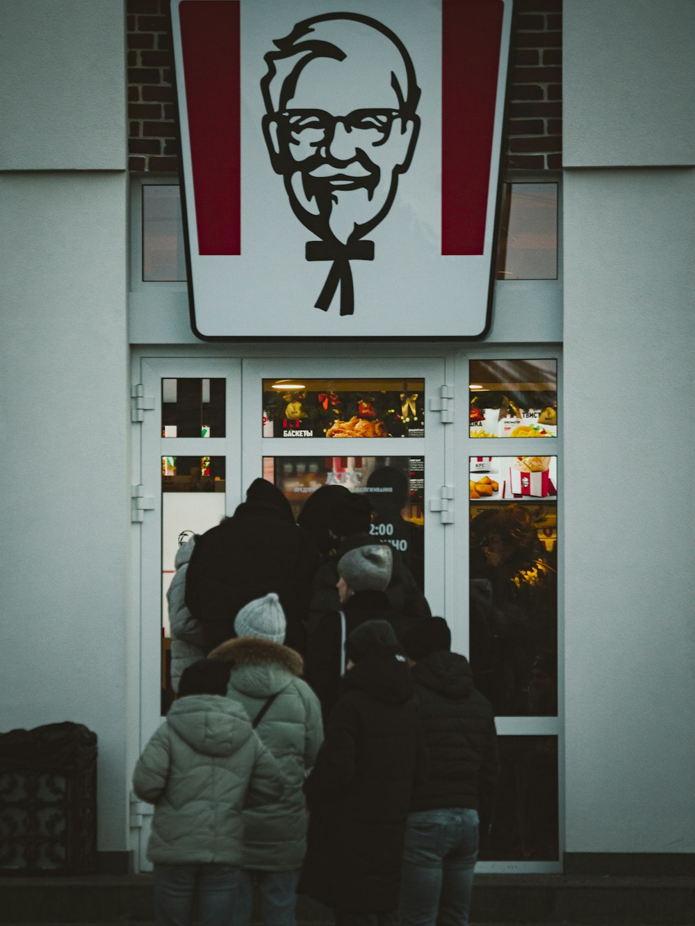 a group of people standing outside of a store