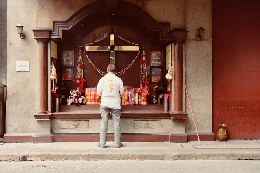 a man standing in front of a shrine