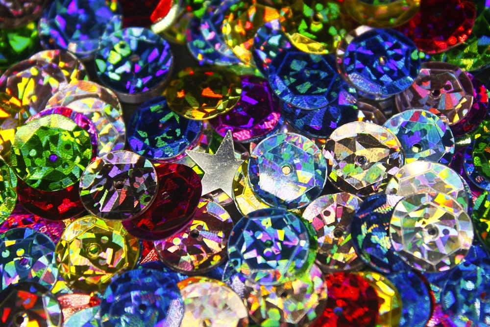 a pile of colorful jewel stones sitting on top of a table